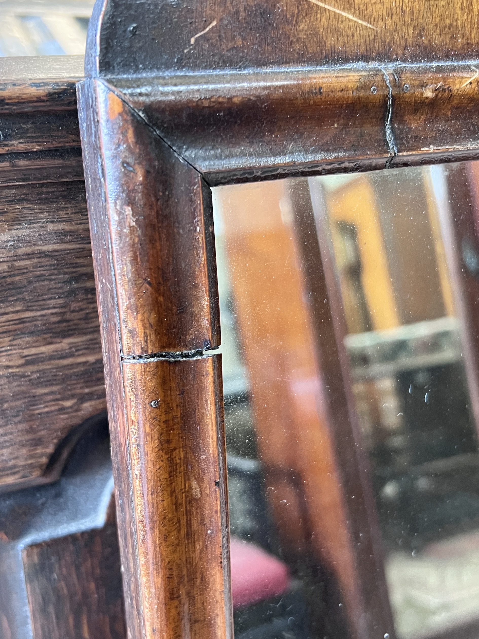 An 18th century walnut fret cut wall mirror, width 36cm, height 68cm